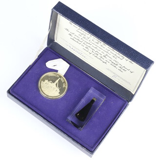 A silver medallion in commemoration of Britain's first North Sea Oil Ashore 1975 together with a sample of crude oil in a perspex container in a fitted case 