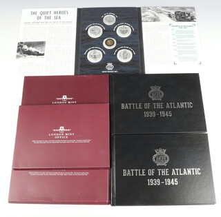 A commemorative coin set - The Battle of The Atlantic 1939-1945 comprising a 22ct gold proof 10 pounds 3.11 grams, 4 silver commemorative crowns each 15.55 grams and a ditto 7.7 grams together with certificates and folder 