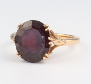A yellow metal 18ct oval cut garnet ring 6.5 grams, size S
