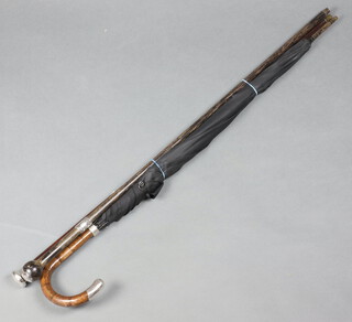 A Victorian silver walking cane with silver knop London 1849, one other and a silver mounted umbrella