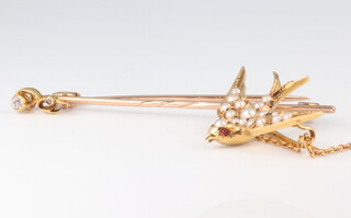 An Edwardian yellow metal 15ct seed pearl swallow brooch 30mm together with a yellow metal diamond set pin brooch