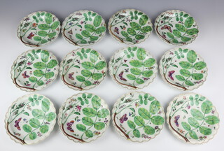 12 Worcester Blind Earl scalloped dessert dishes circa 1765-1770, with moulded relief of rosebuds and leaves with painted flowers insects and butterflies. The rims with gilt C scrolls 19.5 cm diameter