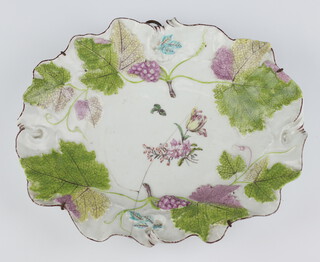 A Chelsea oval dish circa 1755 moulded vinery and grapes the centre decorated painted flowers, brow line rims (rubbed), red anchor mark to base, 23.7 cm wide  