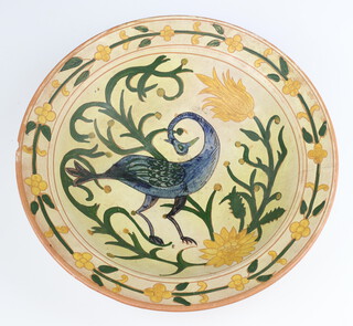 A Della Robbia pottery deep bowl, decorated with a stylised bird amongst flowers, incised mark to back 1894 W (likely Willie Williams), 30cm 