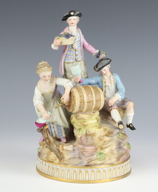 A Meissen group of revellers beside a barrel raised on a rocky base, underglaze blue mark to base and inscribed C.65., 21cm 