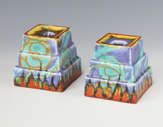 A pair of Clarice Cliff Inspiration pattern stepped candle holders, printed and painted marks 8.5cm 