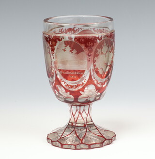 A 19th Century Bohemian red overlay cut glass cup, decorated with panels of park views and flowers 14cm 