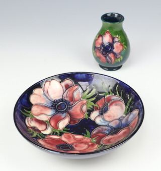 A William Moorcroft blue shallow dish decorated anemones monogram mark 18cm, a cream ground anemone vase impressed marks 10cm 