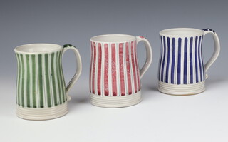 Three Rye pottery mugs decorated with blue, pink and green stripes