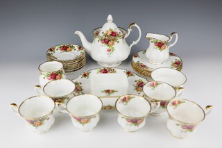 A Royal Albert Country Rose pattern tea set comprising 6 tea cups (2 are seconds, 2 are cracked), 8 saucers (1 cracked), a teapot (second), a sugar bowl and milk jug, a vase (second) a rectangular box (second), 6 small plates and a sandwich plate 
