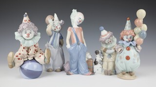 A Lladro figure of a clown playing an accordion 5279 14cm, ditto with a dog 6243 20cm, ditto wearing a top hat with rabbit 14cm, ditto sitting on a ball 5813 18cm and ditto with balloons 5811 12cm 