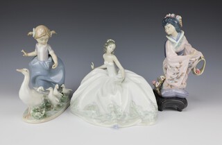 A Lladro figure of a lady holding a fan 5859 14cm, ditto of a girl with geese 5503 17cm and a Japanese lady holding a basket 21cm 