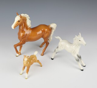 A Beswick Palomino Prancing Arab Type H1261 First Version Palomino gloss by Arthur Gredington 17.2cm a Foal large stretched legs H836 grey gloss by Arthur Gredington 12.7cm and Foal Small,Stretched,Facing Left Palomino gloss by Arthur Gredington 8.3cm