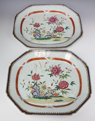 A pair of large Chinese export famille rose oblong octagonal meat platters, Qing dynasty, Qianlong period painted with peonies and other flowers amongst rockwork, 45.5cm by 37cm
     