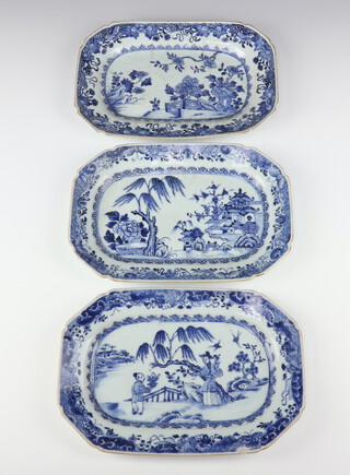 Three Chinese export blue and white oblong octagonal dishes, Qing dynasty, Qianlong period painted with a peony in a fenced garden, a river landscape scene and a lady and child in a garden respectively, all 27cm