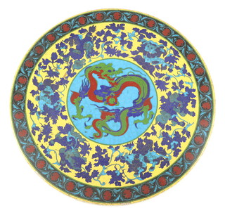 A Japanese circular cloisonne on porcelain dragon plaque, circa 1900, decorated with a central 3 claw dragon bordered with bands of Buddhistic lions on a yellow ground and lotus inscribed to the reverse, 35cm diam