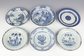 A group of six Chinese export blue and white dishes, Qing dynasty, 18th century comprising a pair of plates each painted with a willow tree, a shallow bowl painted with a basket of flowers, two dishes with a river landscape design and one of Fitzhugh pattern type, ranging from 22.4cm to 25.5cm diam