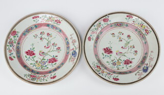 A pair of Chinese export famille rose dishes, Qing dynasty, Qianlong period, each painted with a pair of birds on branches of peony and prunus, 22cm diam