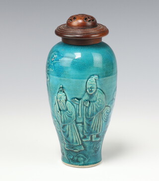 A Chinese turquoise ovoid vase, figures in relief, a lady looking from a window with 2 attendants below, with carved wooden lid, 15.5cm h