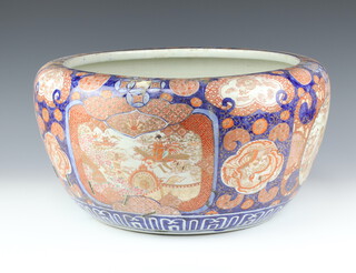 A large Japanese Imari jardiniere, Meiji/Taisho period, painted with panels of immortals dragons and flowers, 48cm diam