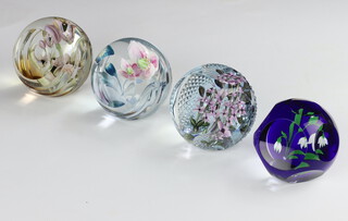 Four Caithness Paperweights by Allan Scott Lilac 38/50 8cm, Belladonna 23/100 8cm Papaver 31/100 and Snowdrop Symphony 32/50 7cm all boxed with certificates