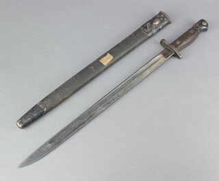 A Wilkinson 1907 patent bayonet complete with leather scabbard, the unmarked blade with broad arrow  