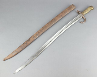 A French chassepot bayonet, the blade dated 1868 with brass grip and metal scabbard