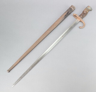 A French chassepot bayonet, the blade dated 1880 with wooden grip and metal scabbard 