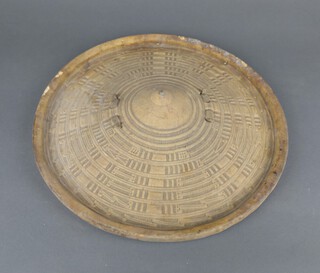 An African circular hide and wooden shield 35cm diam.