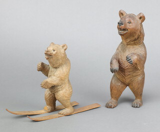 A carved Swiss figure of a skiing bear 14cm (no poles) together with a ditto of a standing bear 19cm 