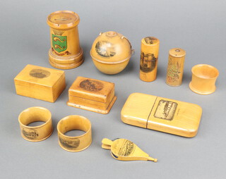 A collection of Mauchline Ware comprising cigar case - Burns Cottage, pin cushion in the form of a pair of bellows - The Strand at Bognor, string box - The Esplanade Bognor, stamp box - High Street East Grinstead, money box in the for of a turret - The Arms of Brighton etc 