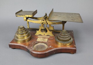 A pair of gilt metal postage scales on an oak base together with 13 weights 19cm h x 38cm w x 29cm d 