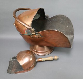 A copper helmet shaped coal scuttle together with an associated shovel 40cm h x 47cm x 28cm