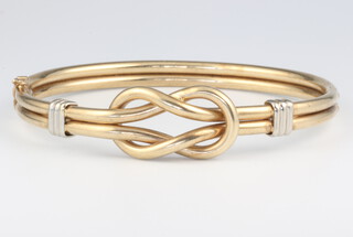 A yellow metal crossover bangle 