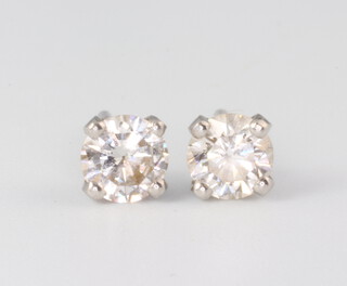 A pair of white metal single stone brilliant cut diamond ear studs, each approx 0.5ct 
