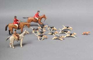 New Forest Toys, Brockenhurst, a carved wooden hunting group comprising 2 huntsmen with rider, 1 lady follower, 10 hounds and 1 fox,  Made in the New Forest attributed to Frank Whittington (1876-1973) 