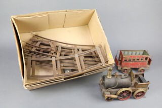 A 19th Century brass scratch built steam locomotive 17cm h x 22cm l with associated carriage and track (track width 8cm) 