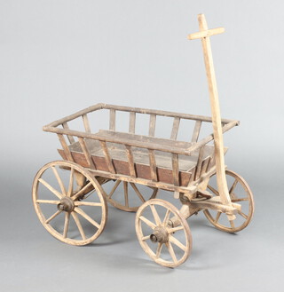 A 19th Century child's wooden pull along cart with iron shod wheels 54cm h x 76cm l x 46cm w 