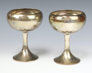 A pair of stylish silver cups with wide flared bases 658 grams, Sheffield 1911, retailed and made by Kemp Brothers of Bristol 17cm 