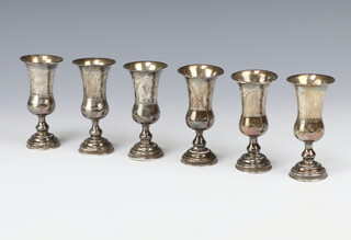 A set of 6 white metal Kiddish cups with engraved floral decoration, London import marks 1902, 202 grams 