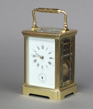 A 20th Century carriage, striking on gong alarm clock, with 6cm enamelled dial, Roman numerals, alarm dial, contained in a gilt metal case complete with key 13cm h x 9cm w x 7.5cm d 