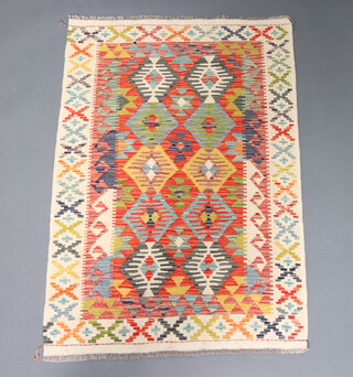 A white, turquoise, green and tan ground Chobi Kilim rug 145cm x 98cm 