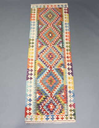 A white, green and turquoise ground Chobi Kilim runner with diamond decoration to the centre 247cm x 78cm 