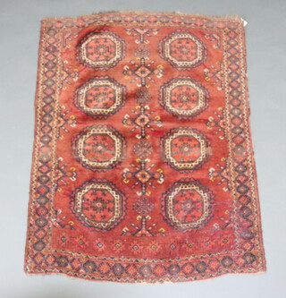 A red and blue ground Afghan rug with 8 octagons to the centre within a multi row border 147cm x 108cm 