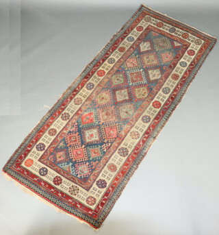 A blue, turquoise and white ground Caucasian rug with 21 hooked diamonds to the centre within a 2 row border 264cm x 111cm (in wear) 