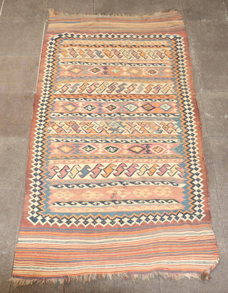 A blue, tan and white ground Kilim rug with all over geometric design 282cm x 146cm 