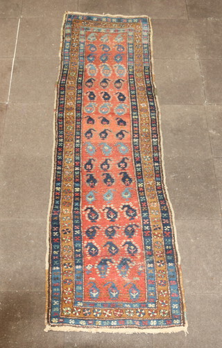 A pink, blue and white ground Kilim runner with all over hook design to the centre within a 3 row border 277cm x 77cm 