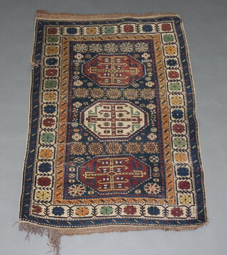 A blue, brown and white ground Caucasian rug with 3 octagons to the centre 141cm x 102cm 