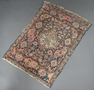 A pink, blue and white ground Persian rug with central medallion within a multi row border 128cm x 97cm 