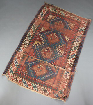 A brown, blue and white ground Caucasian rug with 4 diamonds to the centre within a multi row border 193cm x 119cm 